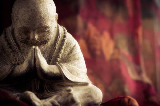praying stone buddha